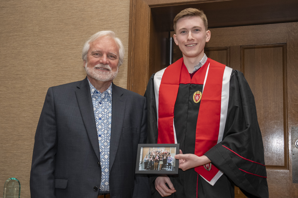 PharmTox Brunch at Carson Gulley May 11, 2024. (Photo © Andy Manis) A student accepts a class photo from Jeff Johnson