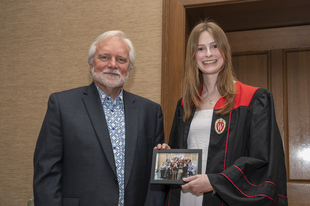 PharmTox Brunch at Carson Gulley May 11, 2024. (Photo © Andy Manis) A student accepts a class photo from Jeff Johnson