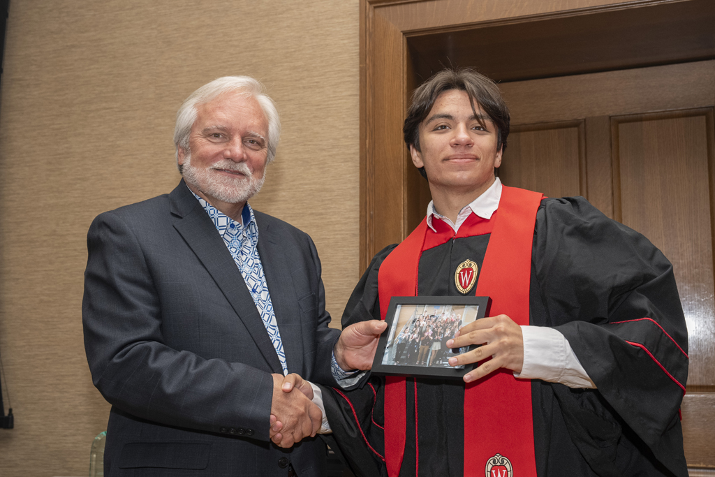 PharmTox Brunch at Carson Gulley May 11, 2024. (Photo © Andy Manis) Adam Eckhart accepts a class photo from Jeff Johnson