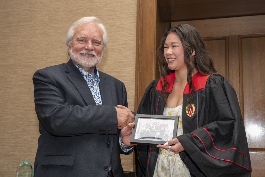 PharmTox Brunch at Carson Gulley May 11, 2024. (Photo © Andy Manis) A student accepts a class photo from Jeff Johnson