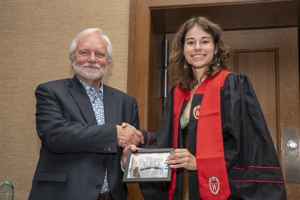 PharmTox Brunch at Carson Gulley May 11, 2024. (Photo © Andy Manis) Isabella Jones accepts a class photo from Jeff Johnson