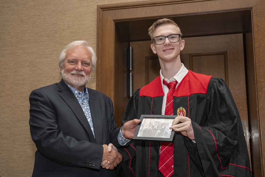 PharmTox Brunch at Carson Gulley May 11, 2024. (Photo © Andy Manis) A student accepts a class photo from Jeff Johnson