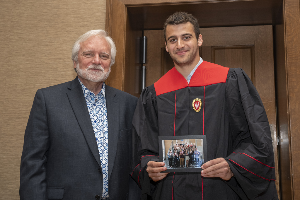 PharmTox Brunch at Carson Gulley May 11, 2024. (Photo © Andy Manis) A student accepts a class photo from Jeff Johnson