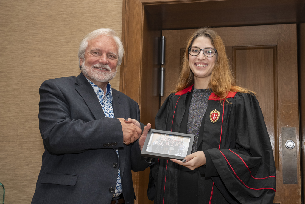PharmTox Brunch at Carson Gulley May 11, 2024. (Photo © Andy Manis) A student accepts a class photo from Jeff Johnson