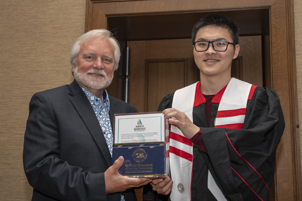 PharmTox Brunch at Carson Gulley May 11, 2024. (Photo © Andy Manis) A student receives a Merck Award from Jeff Johnson