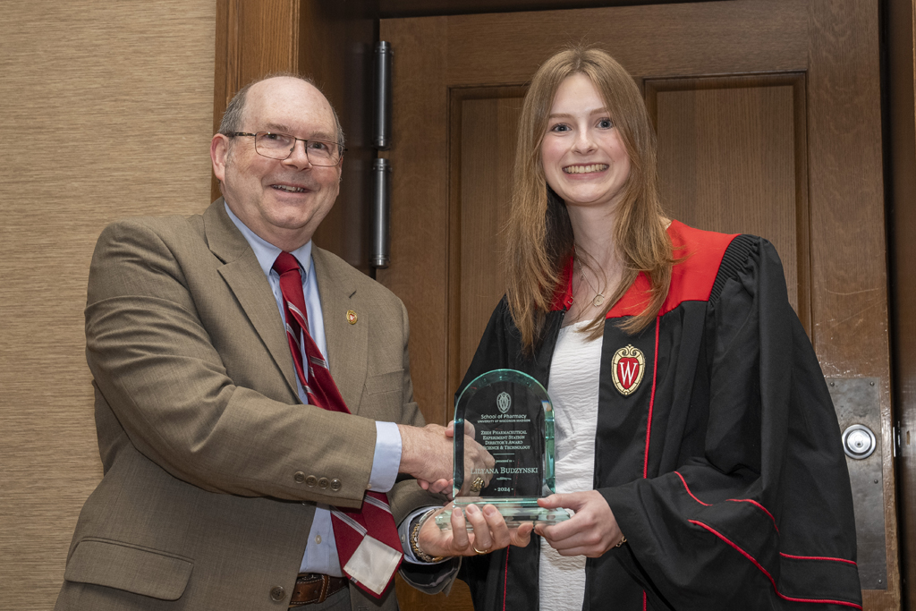 PharmTox Brunch at Carson Gulley May 11, 2024. (Photo © Andy Manis) Leyana Budzynski receives an award from Ed Elder
