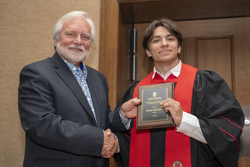 PharmTox Brunch at Carson Gulley May 11, 2024. (Photo © Andy Manis) Adam Eckardt receives an award from Jeff Johnson