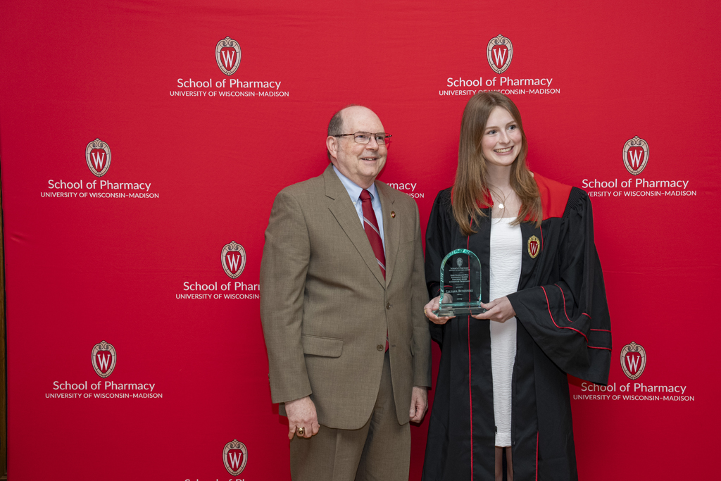 PharmTox Brunch at Carson Gulley May 11, 2024. (Photo © Andy Manis) Ed Elder and a graduate pose with an award from the Zeeh Station