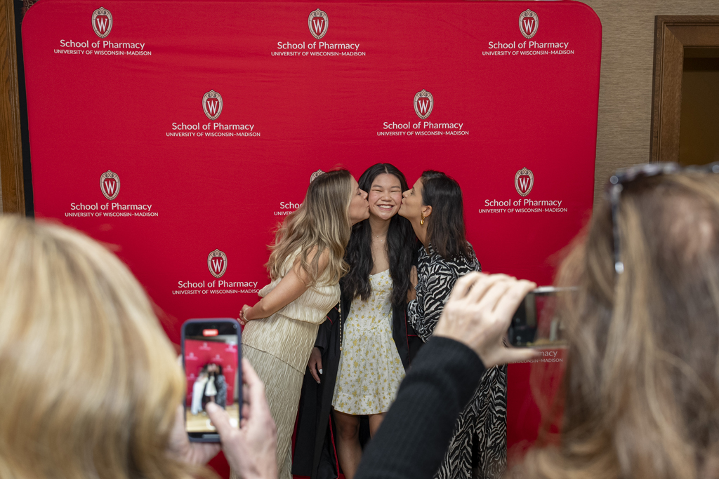 PharmTox Brunch at Carson Gulley May 11, 2024. (Photo © Andy Manis) A graduate gets kisses on each cheek from family members