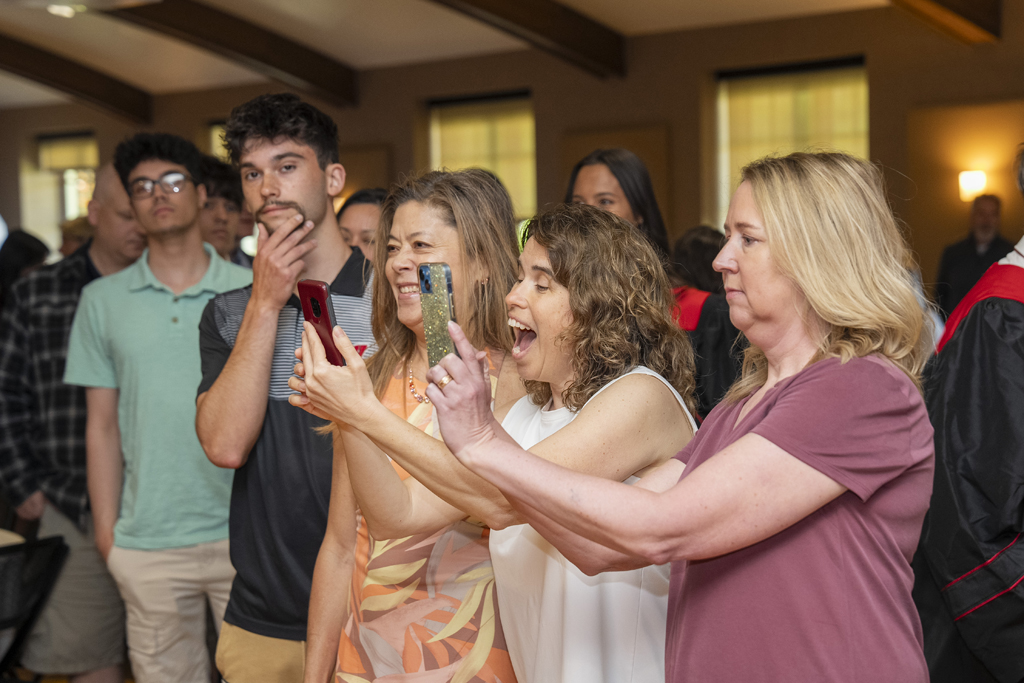 PharmTox Brunch at Carson Gulley May 11, 2024. (Photo © Andy Manis) Family members smile and take photos