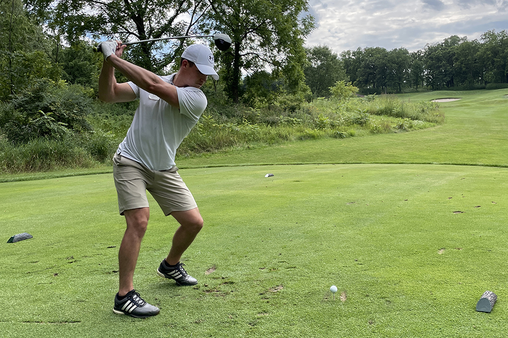 96E0B1CD-23AD-466F-867F-6EF45F6B1523 An alum taking a swing on the green.
