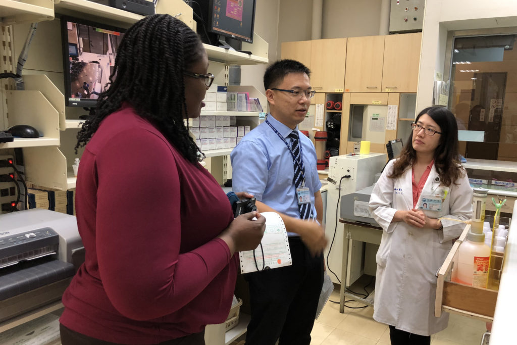 CMUH Pharmacy- Rx manager Olayinka Shiyanbola and Jack speaking with staff from China Medical University