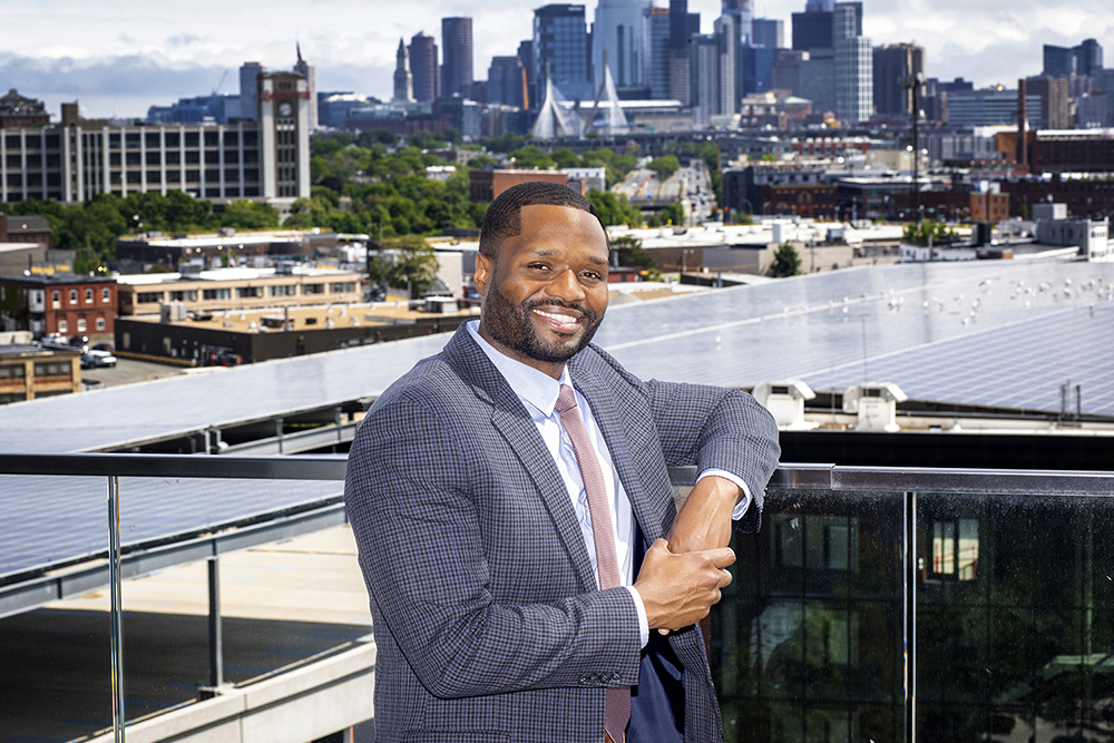 Jevon Oliver posed in front of the Boston skyline