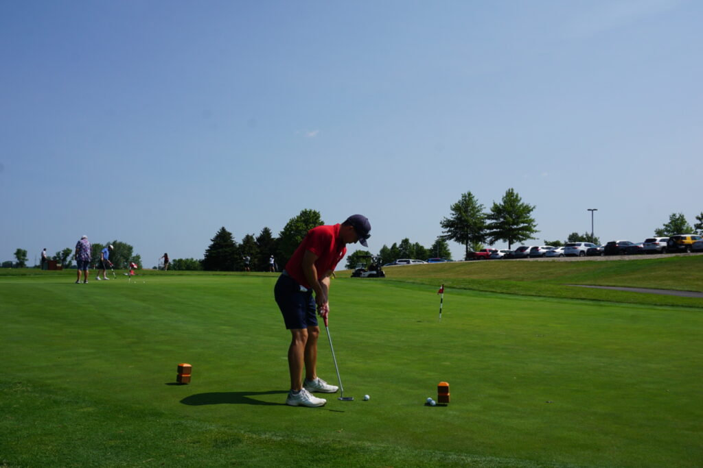 DSC07286 An alumni getting ready to put his ball in on a golf course