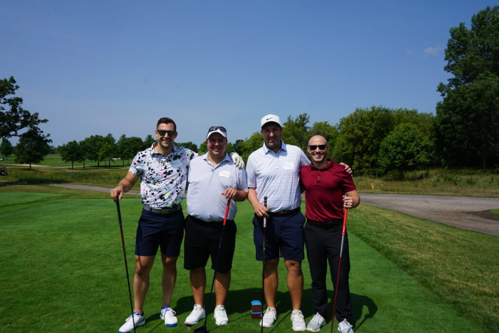 DSC07300 Alumni taking a group picture together at a golf course