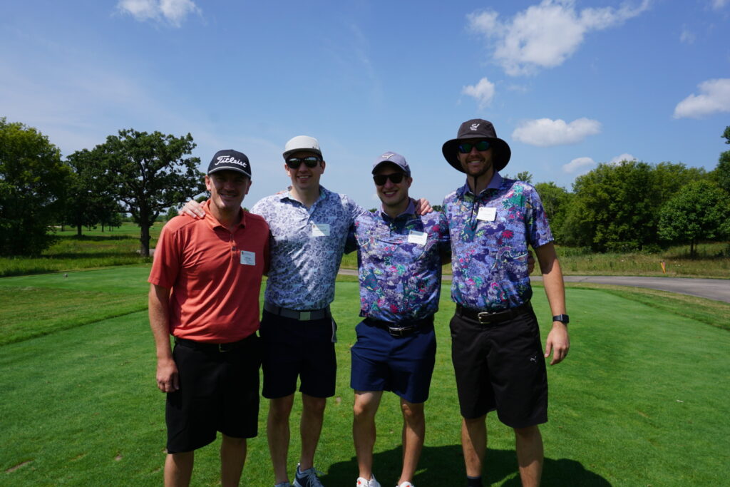 DSC07314 Alumni taking a group picture together at a golf course
