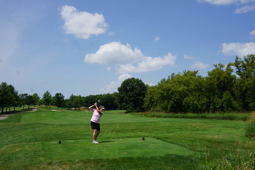 DSC07330 A badger alumni mid-swing at a golf course