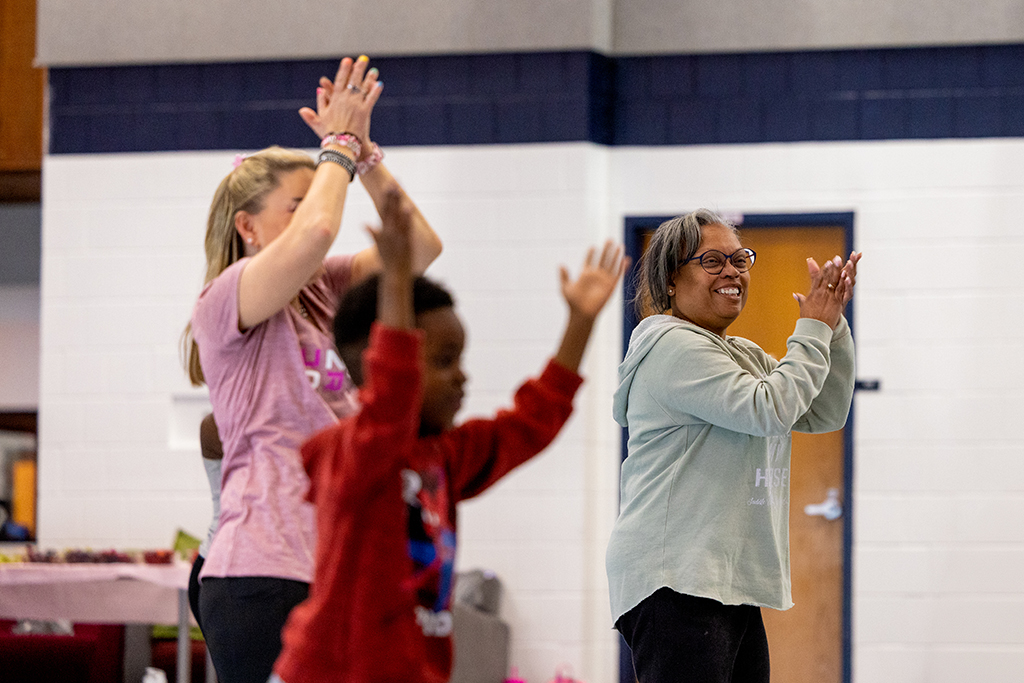 Eva Vivian and other class attendees clap and dance