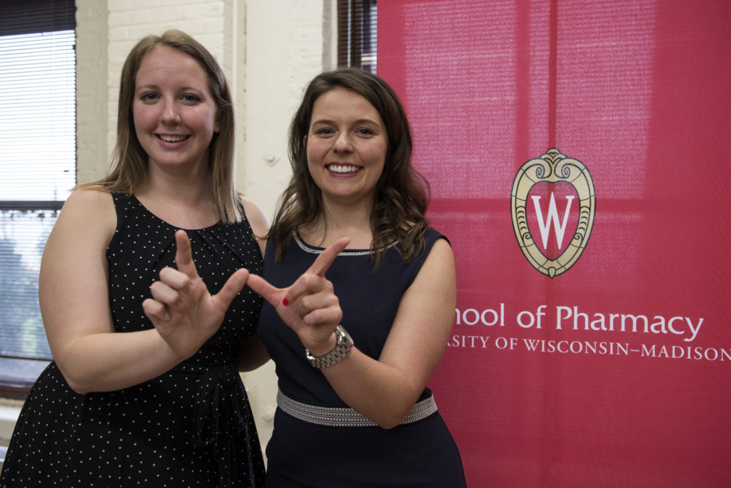 Graduation Awards Celebration_May 2018_DSC2370 Olivia Fahey and Joanne Kuznicki holding up "W"'s