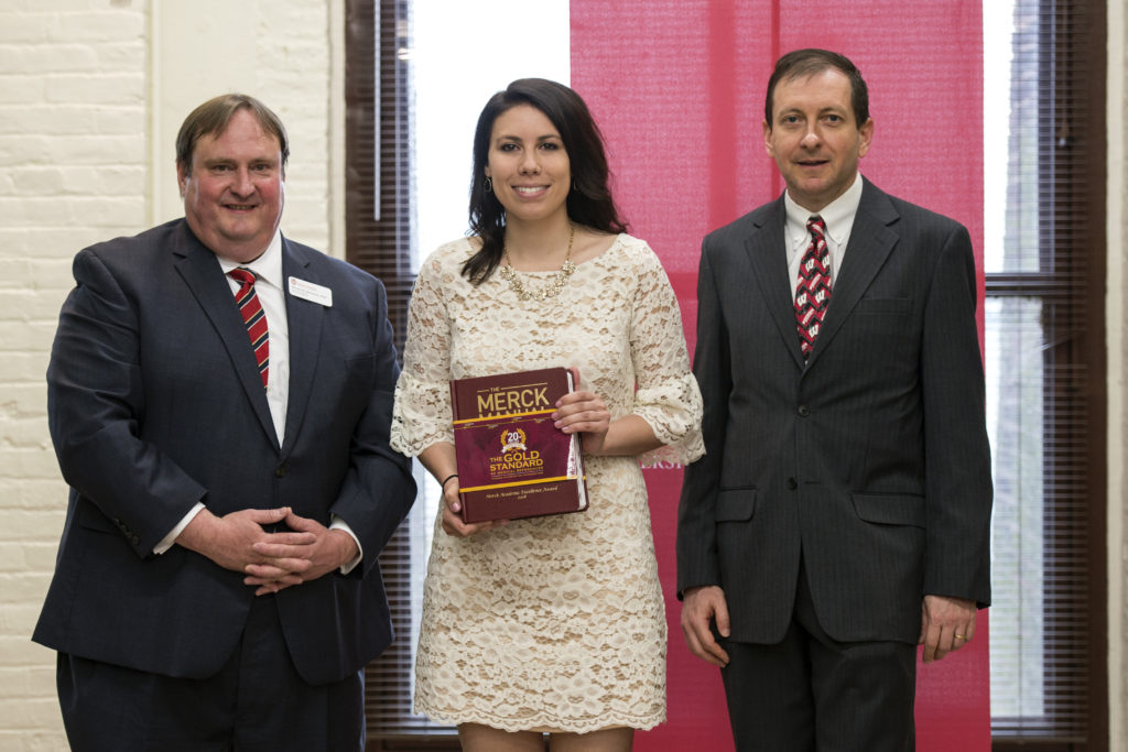 Graduation Awards Celebration_May 2018_PLN3388 (1) Steve Swanson, Paige Fingerson holding her Merck manual, and Eric Buxton