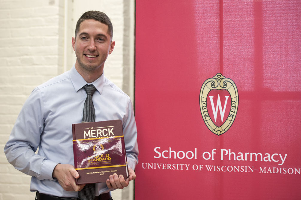 Graduation Awards Celebration_May 2018_PLN3655_1 Jared Baxa holding the Merck manual