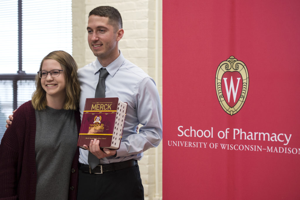 Graduation Awards Celebration_May 2018_PLN3679 Jared Baxa holding Merck manual with his sister
