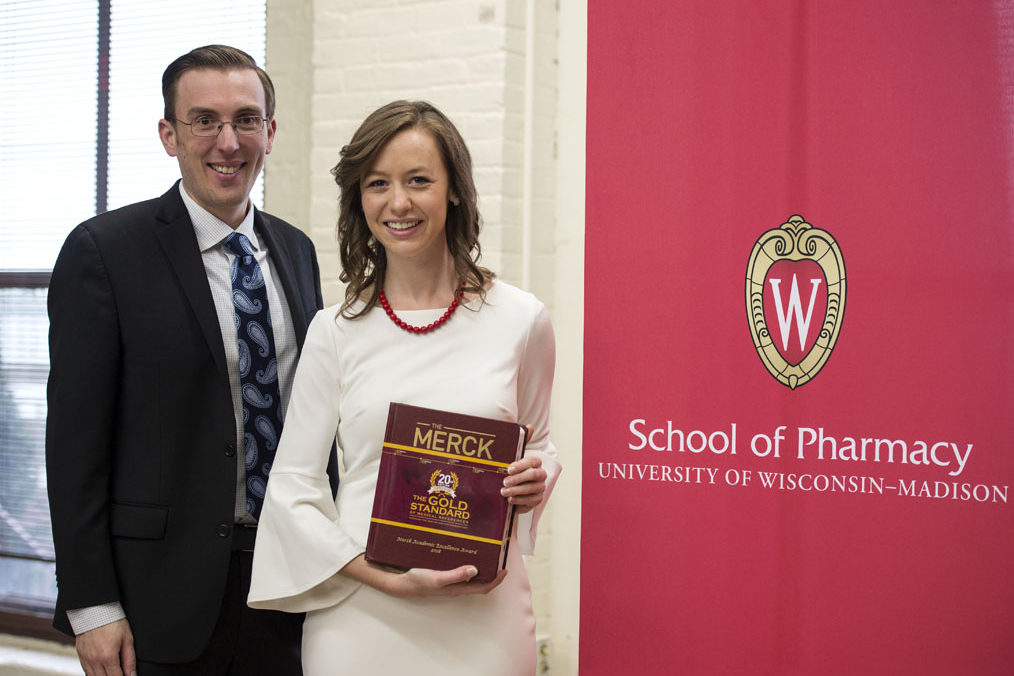 Graduation Awards Celebration_May 2018_PLN3719_1 Kayla Huebner holding Merck manual with David Hager