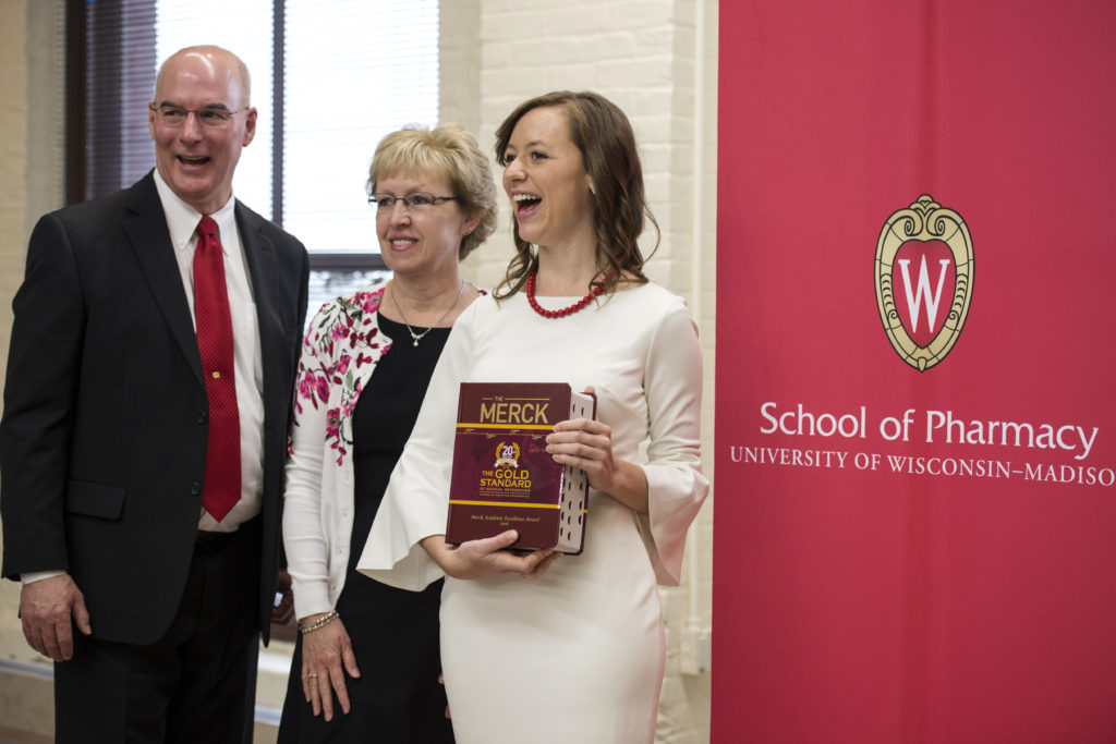 Graduation Awards Celebration_May 2018_PLN3728 Kayla Huebner holding Merck manual with her parents