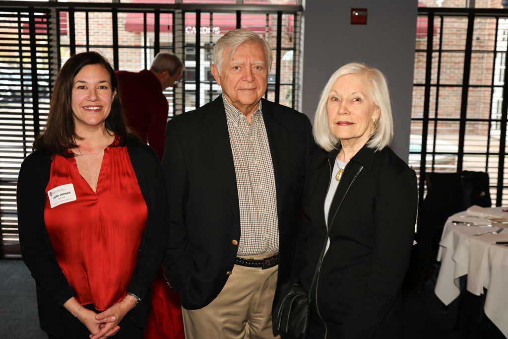 Julie Jensen poses with two attendees