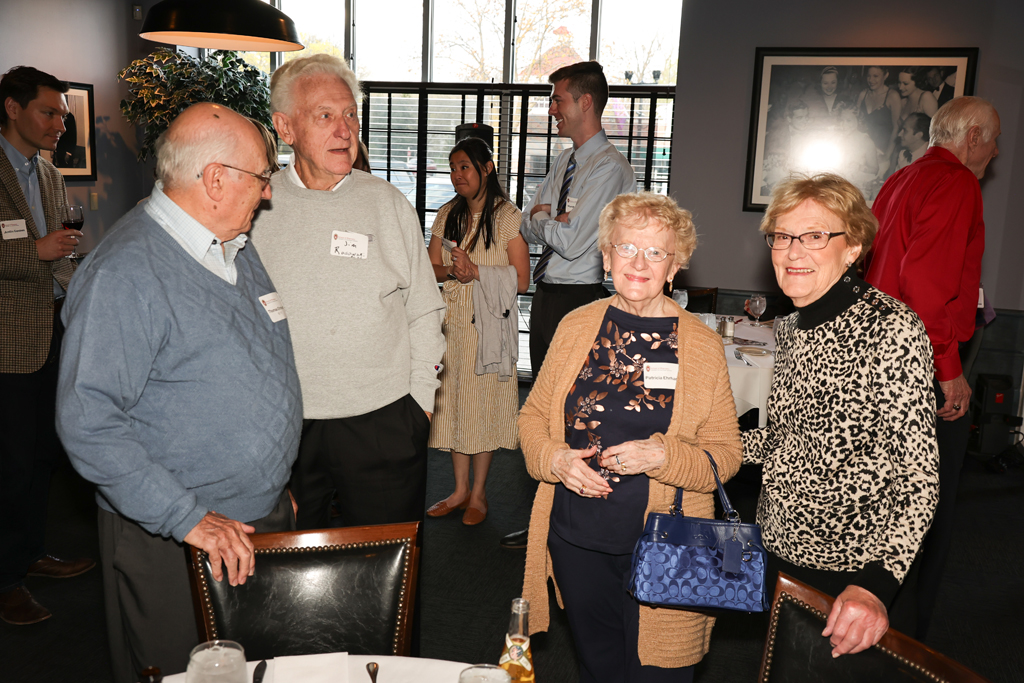 A group of alumni smile