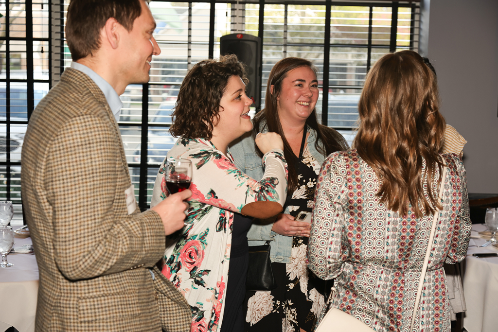 A group of alumni laugh