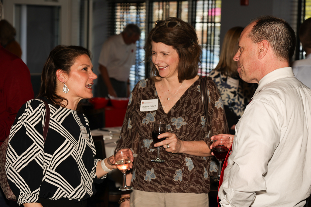 Angela de Ianni speaks with Debbie and Mike Gillard speak as a group