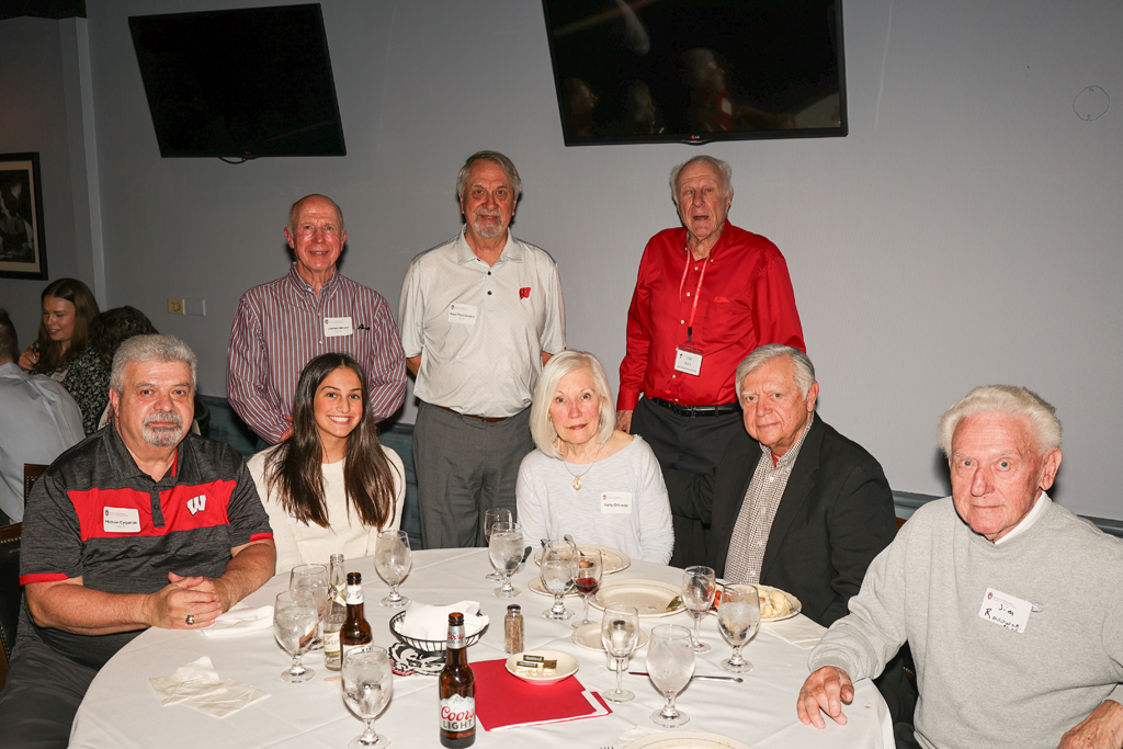 A group of older alumni at a table
