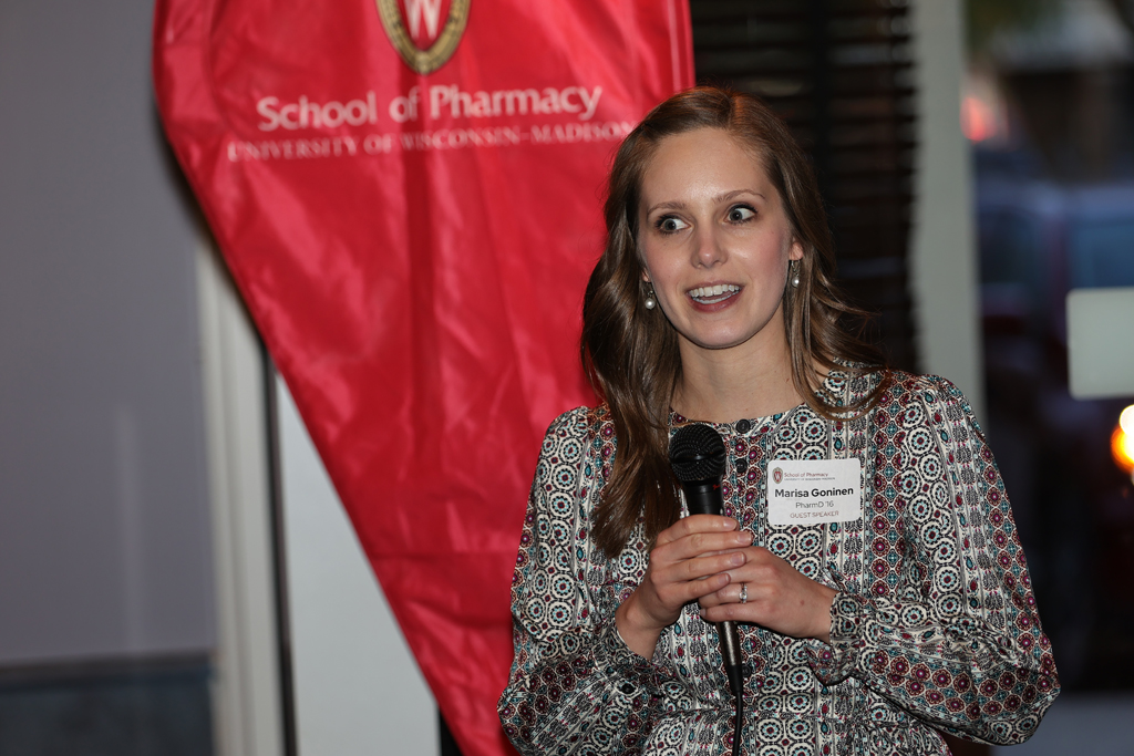 Marisa Gonien speaks with a microphone in her hand.