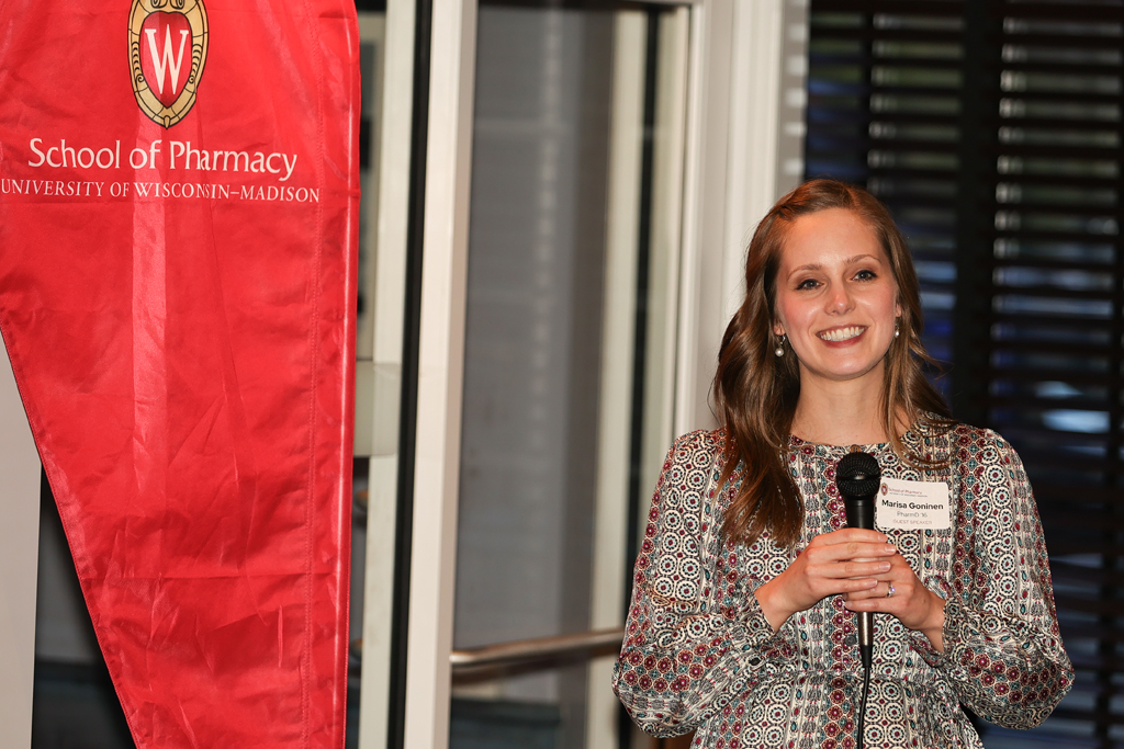 Marisa Gonien speaks with a microphone in her hand.