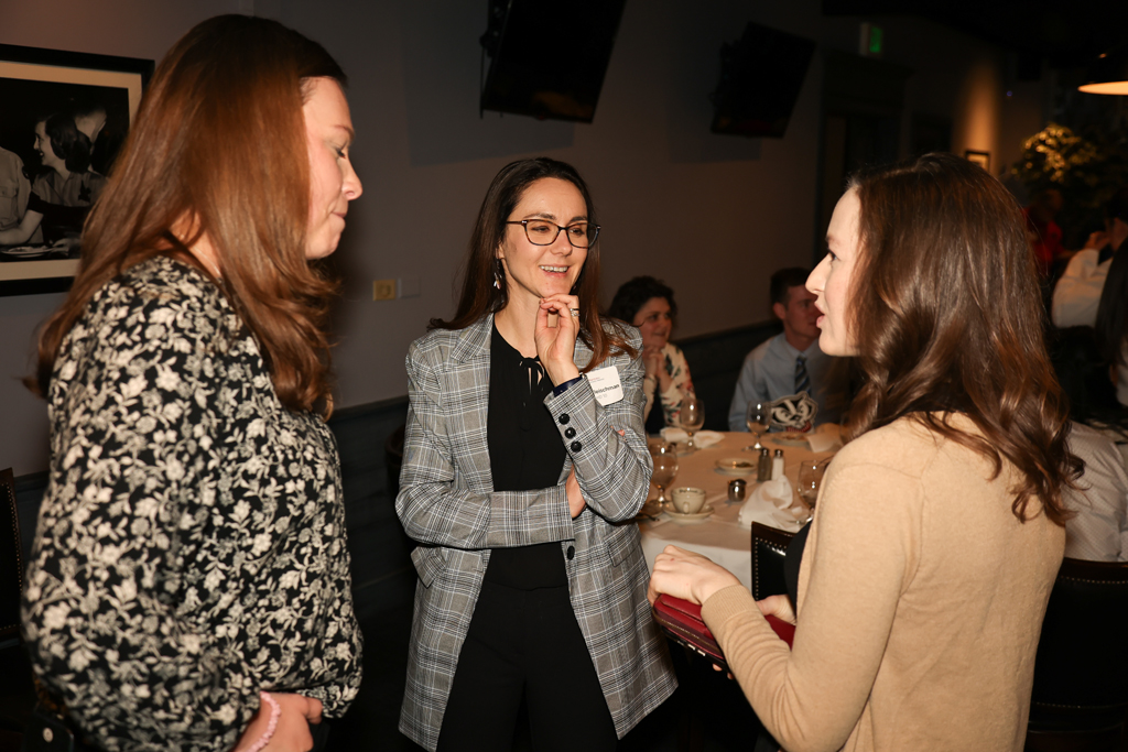 Three women talk in a group