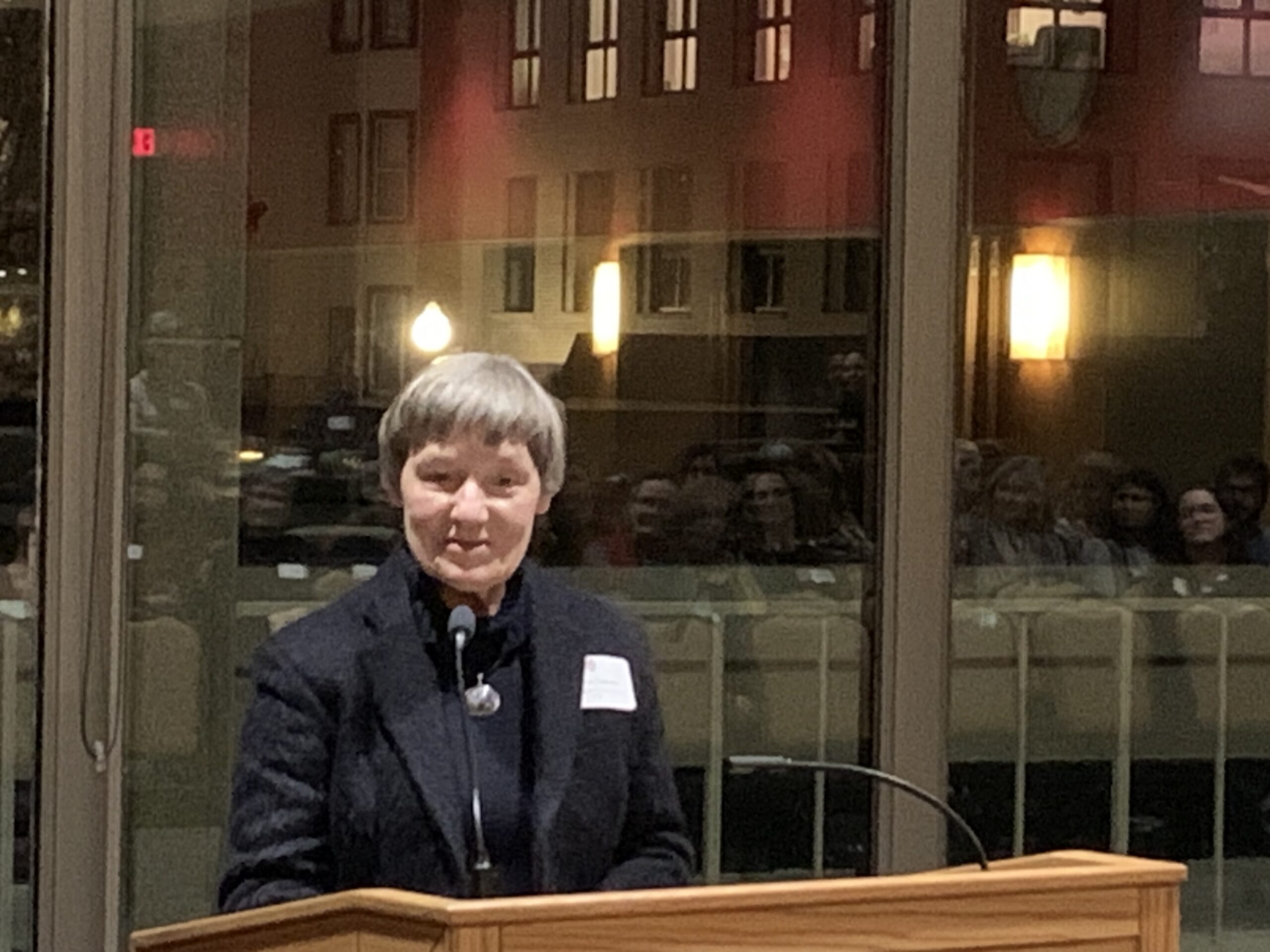Christine Sorkness speaks at a podium