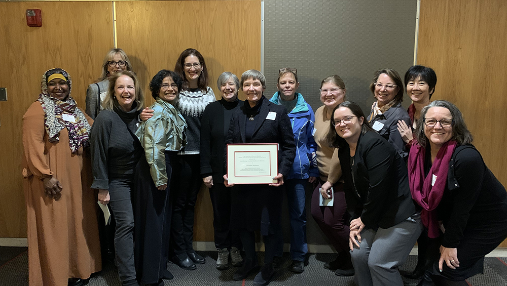 Professor of Pharmacy Practice Christine Sorkness (center) with friends and colleagues at the 2023 Slesinger Award ceremony.