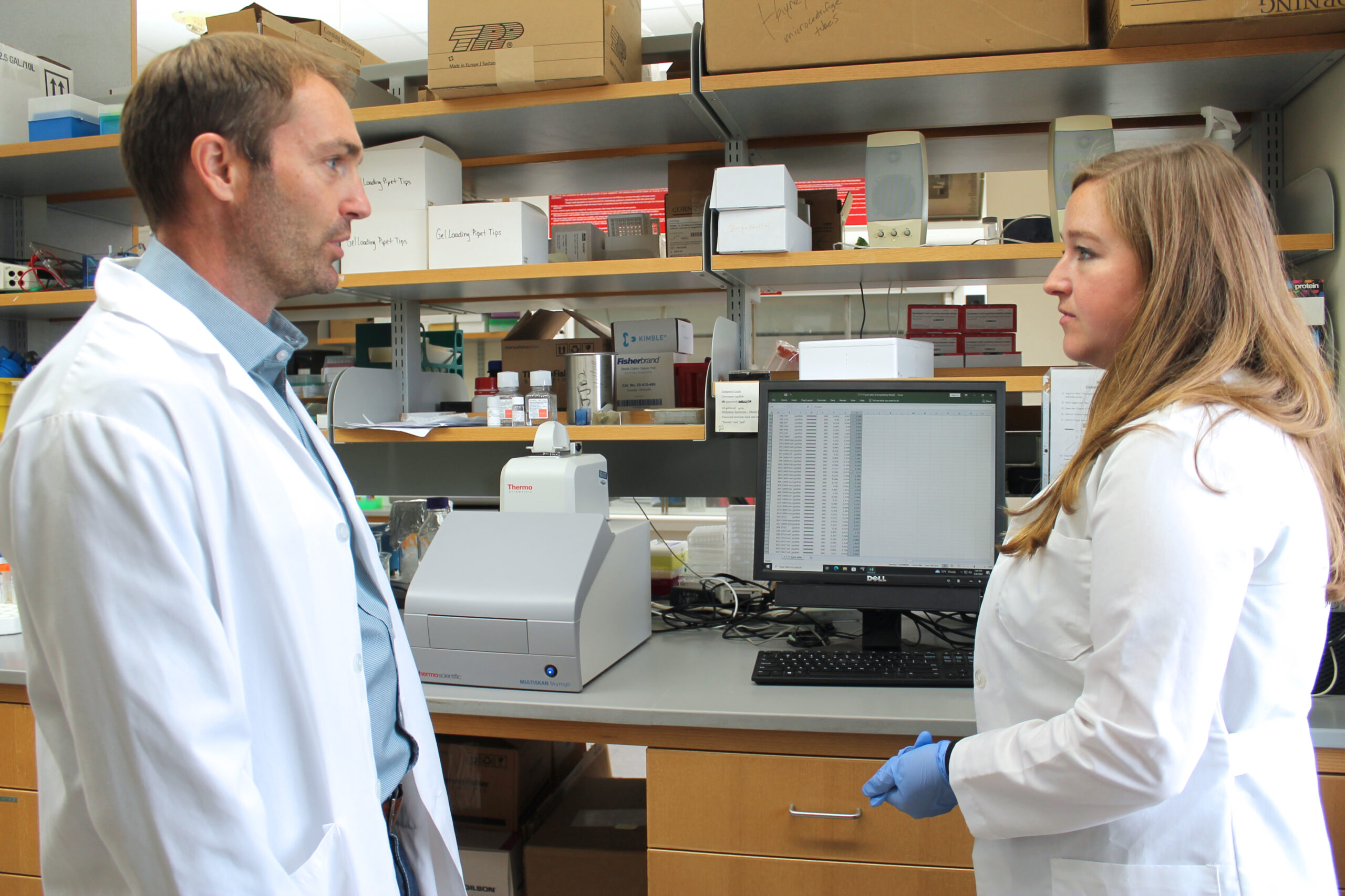 Warren Rose and Cecilia Volk working in the lab