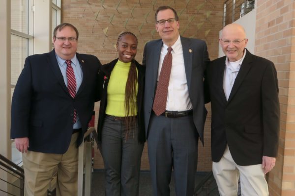 IMG_8412_provost Steve Swanson, Cierra Brewer, Provost Karl Scholz, and Ron Burnette all standing arm-in-arm in Rennebohm Hall