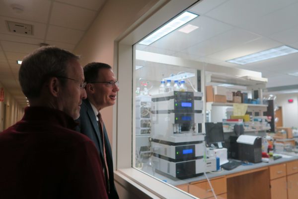 IMG_8501 Dave Mott and Provost Karl Scholz looking into a pharmaceutical lab