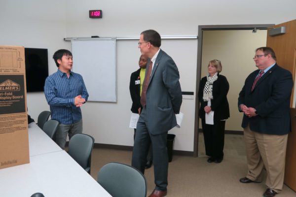 IMG_8727 Kong Vang speaking to Provost Karl Scholz while Cierra Brewer and Dean Steve Swanson listen on the side