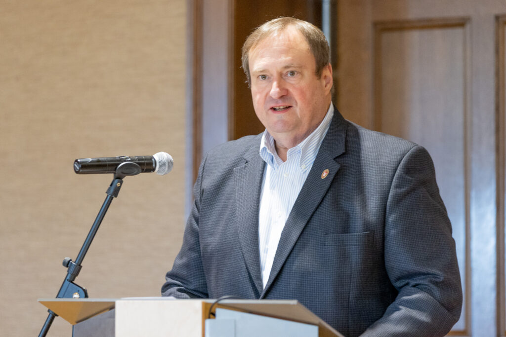 Dean Steve Swanson speaking at the podium.