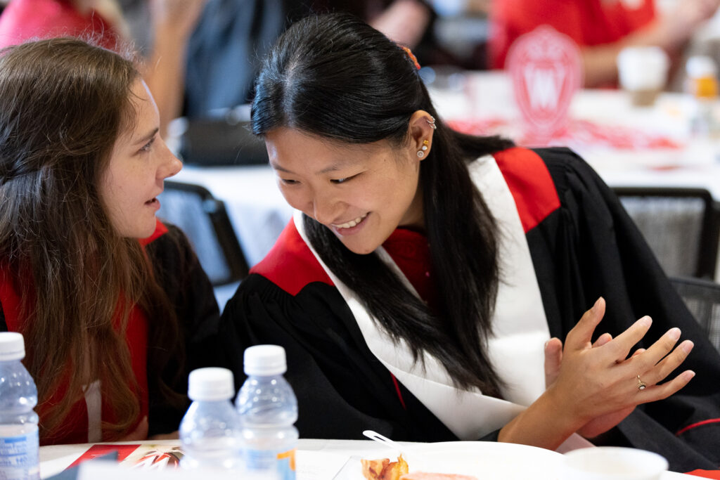 PharmTox students speak at a table.