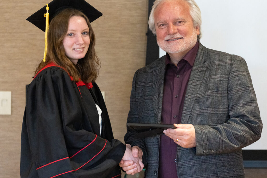 Jeff Johnson and a PharmTox graduate pose for a photo.