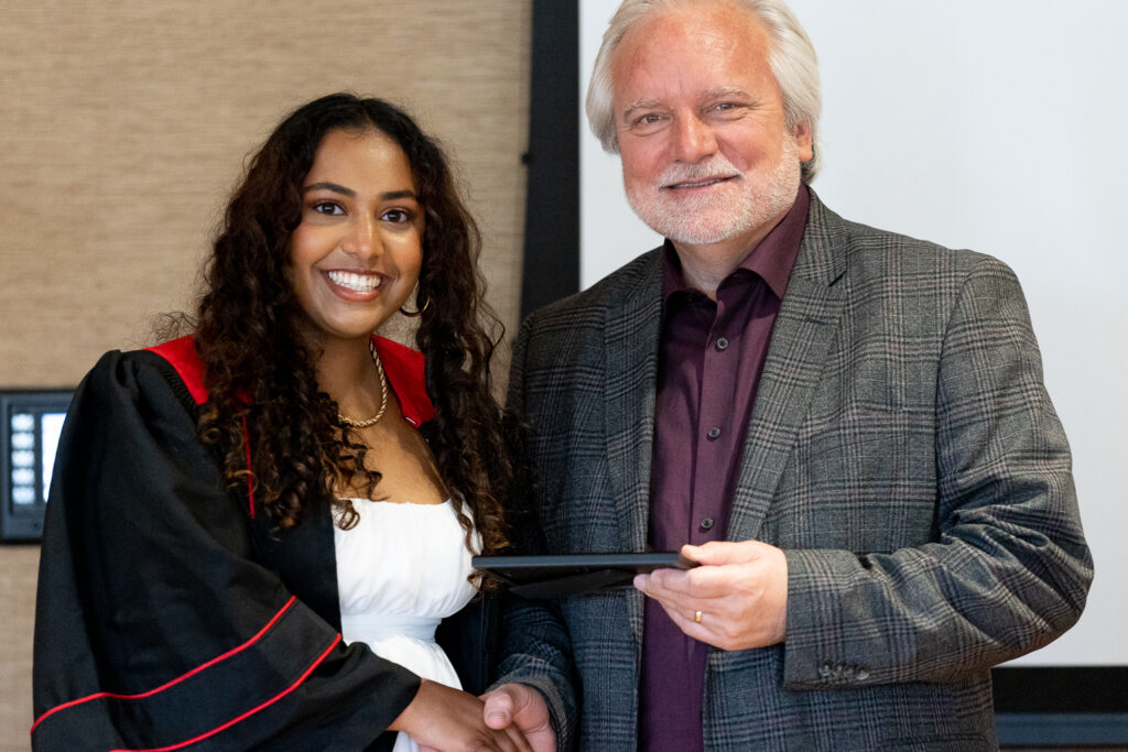 Jeff Johnson and a PharmTox graduate pose for a photo.