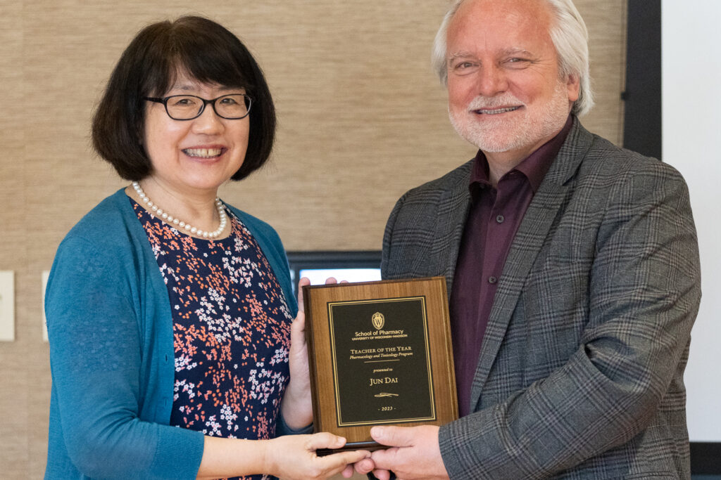 Jun Dai and Jeff Johnson pose with her Teacher of the Year award.