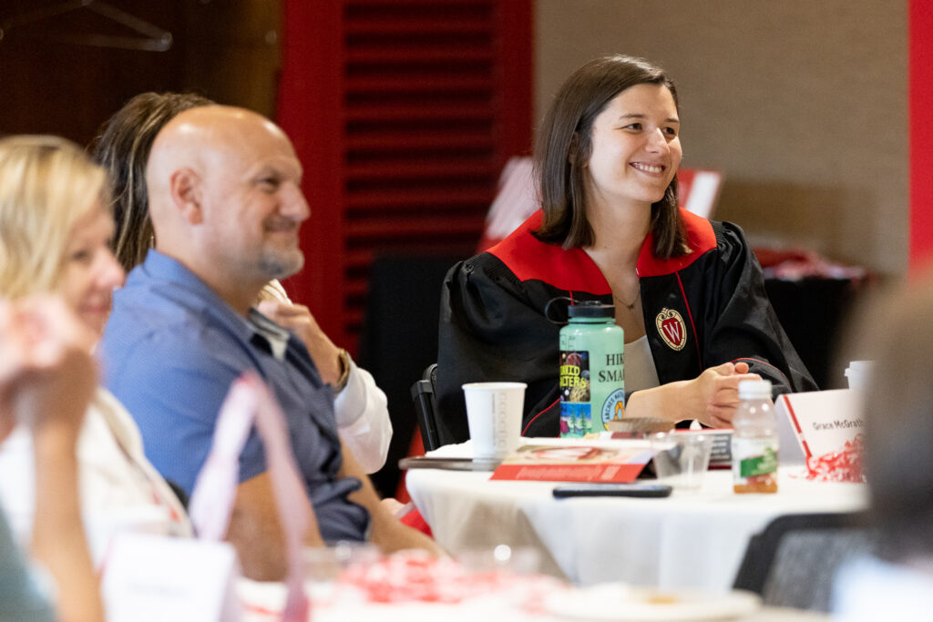 PharmTox grad with her family at a table.