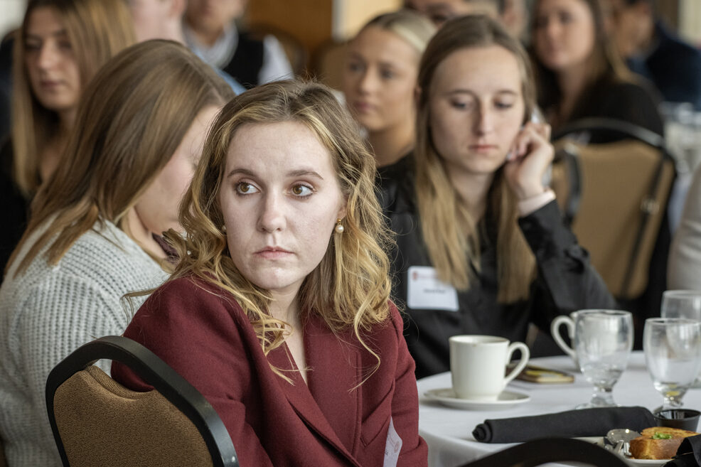 Alissa Cassady listening to speaker with students behind her out of focus