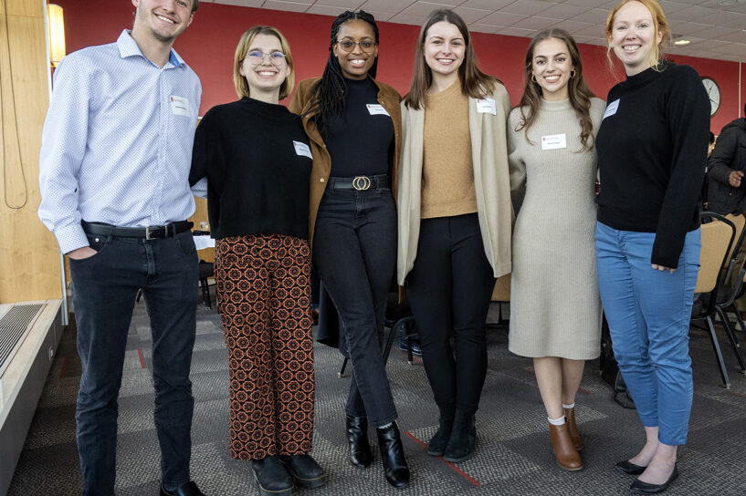 Heather Spatchek standing arm-in-arm with students